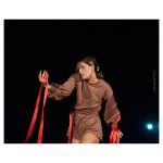 A performer covered in ribbons whilst moving